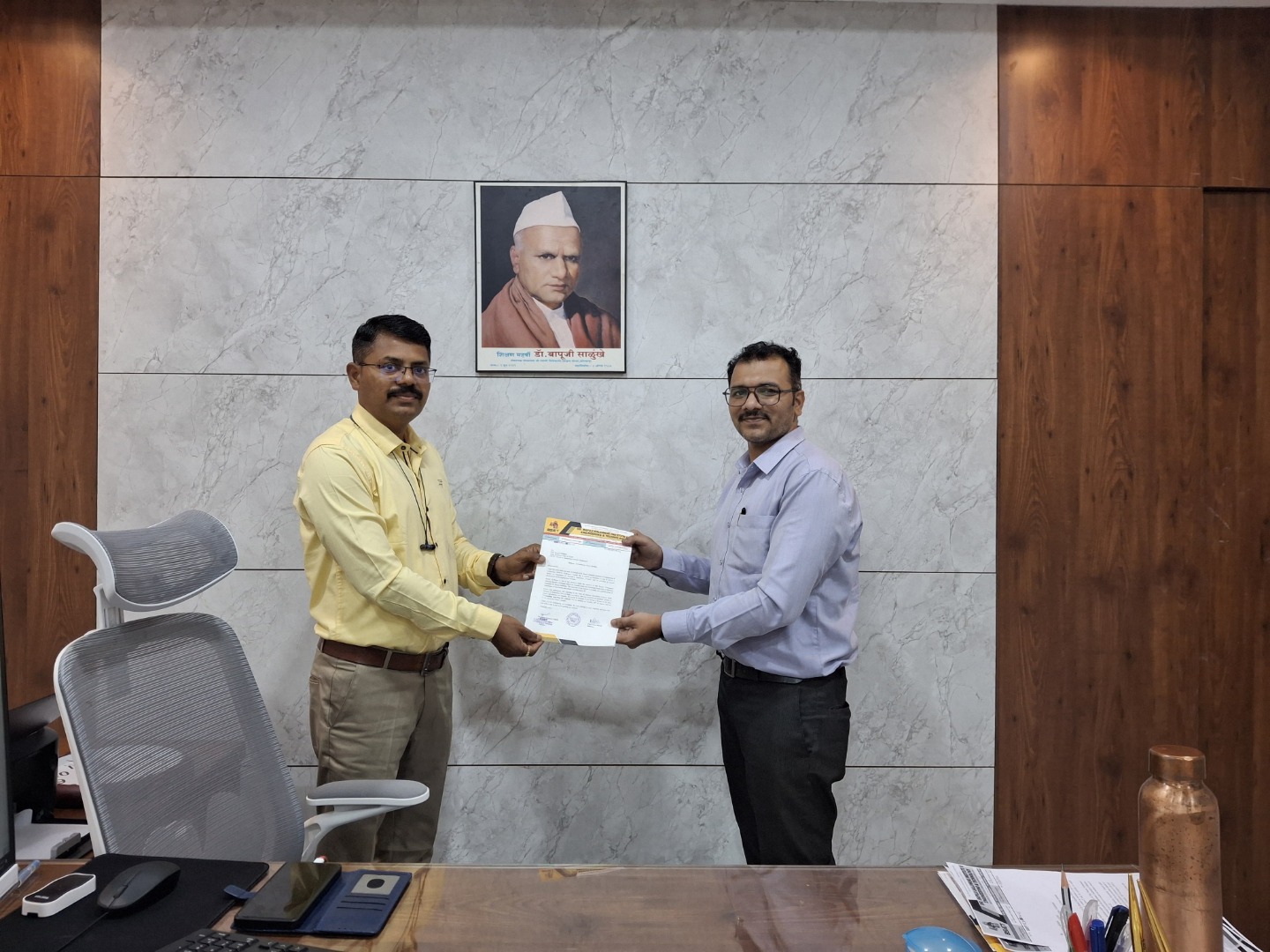 Principal Sir presenting appreciation letter to Professor Deepak Mahajan